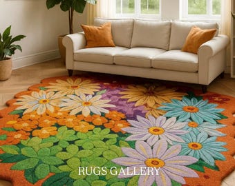 May include: A colorful, floral-shaped rug with a scalloped edge. The rug features large daisy-like flowers in shades of yellow, orange, purple, blue, and green, set against an orange background. The text "RUGS GALLERY" is visible on the rug.