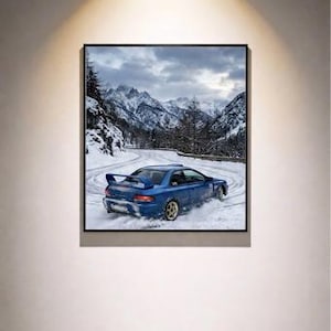 May include: A framed print of a blue sports car drifting on a snowy mountain road. The car is the focal point, with snow spraying from its tires. The background features snow-covered mountains and a cloudy sky.