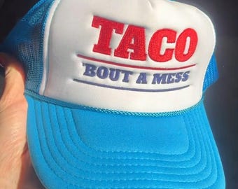 TACO Bout a Mess | Embroidered Foam Trucker Hat l Funny Anti-Trump Trucker Hat | Democrat Hat | Pro-Liberty Hat | Political Gift