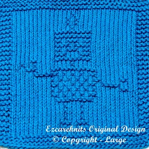 May include: A bright blue knitted dishcloth with a geometric pattern. The dishcloth is square and has a textured surface. The text "Ezcareknits Original Design © Copyright - Large" is printed in white at the bottom of the dishcloth.