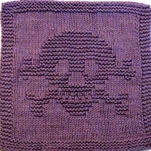 May include: Purple knitted dishcloth with a skull design.