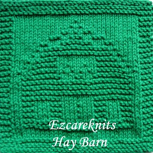 May include: A green knitted dishcloth with a textured pattern. The dishcloth has the text "Ezcareknits Hay Barn" in white.