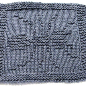 May include: A blue knitted dishcloth with a woven pattern. The dishcloth is square and has a textured surface.