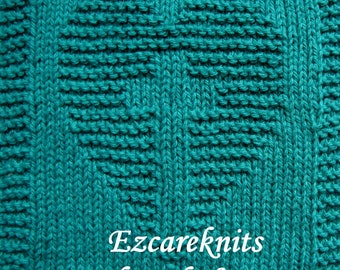 May include: A teal knitted square with a heart pattern in the center. The text "Ezcareknits Blessed Heart" is at the bottom of the square.