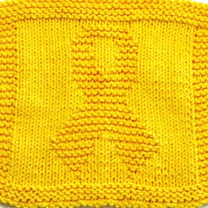 May include: A yellow knitted dishcloth with a geometric pattern.