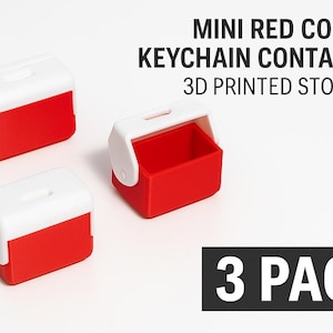May include: Miniature red and white cooler keychain containers. The 3D-printed storage containers have a rectangular shape with a white lid and a red base. The text on the image reads "MINI RED COOLER KEYCHAIN CONTAINER 3D PRINTED STORAGE" and "3 PACK".