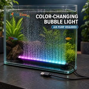 May include: A color-changing LED bubble light bar for aquariums with a black base and a USB power cable. The light emits purple and blue hues, illuminating a vertical stream of bubbles inside a glass tank with green plants and small fish.