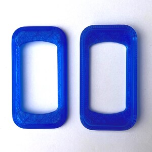May include: Two blue rectangular frames with rounded corners are displayed against a white background. The frames have a textured appearance, suggesting a 3D-printed design. The frames are identical in shape and size.