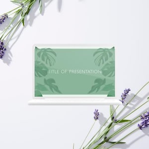 May include: A white laptop displays a presentation screen with a green background and leaf silhouettes. The text "TITLE OF PRESENTATION" is visible. Lavender sprigs with purple flowers are arranged around the laptop on a white surface.