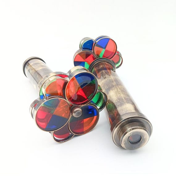 A solid brass kaleidoscope with hand-engraved floral work — a genuine heirloom-quality optical object that looks like it belongs in a Victorian cabinet of curiosities.