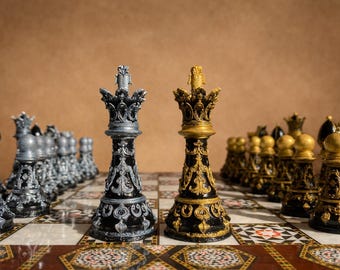 May include: A detailed shot of a chess set with black and silver pieces facing gold and black pieces on a decorative board. The kings are in the foreground, with other pieces lined up behind them. The background is a solid brown.