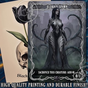 May include: A rectangular trading card titled Eldrazi Spawn featuring a dark-haired humanoid figure with black vine-like markings, standing before dark tentacles. The card includes the text Sacrifice this creature: add and the number 0/1.