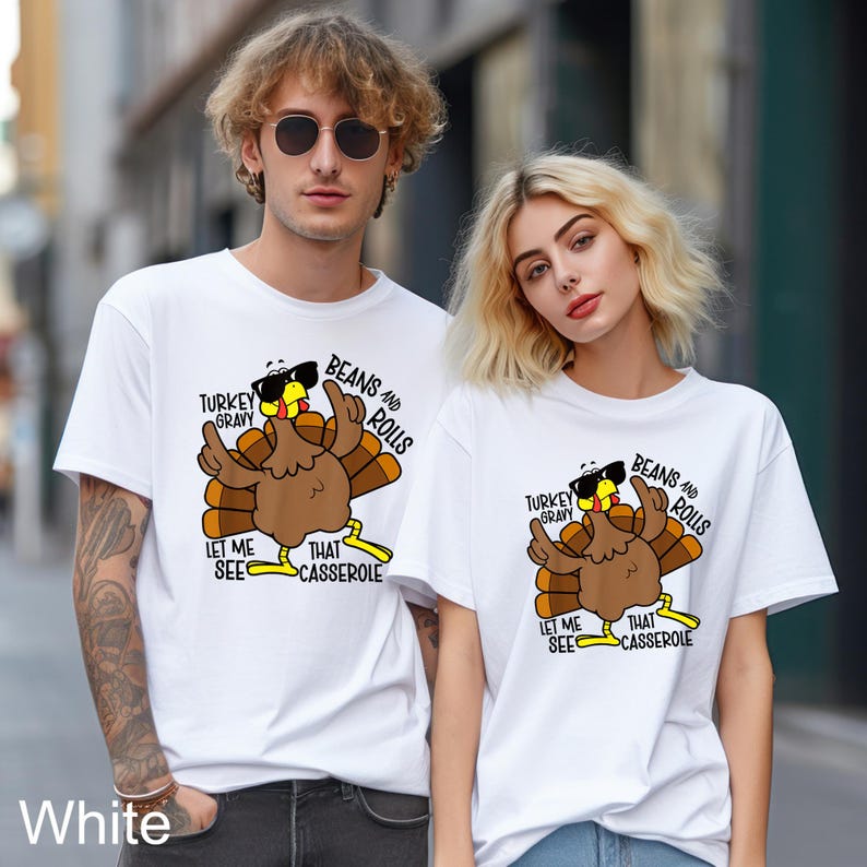 May include: Two white t-shirts with a cartoon turkey wearing sunglasses and the text "TURKEY GRAVY BEANS AND ROLLS LET ME SEE THAT CASSEROLE". The shirts are a casual style.