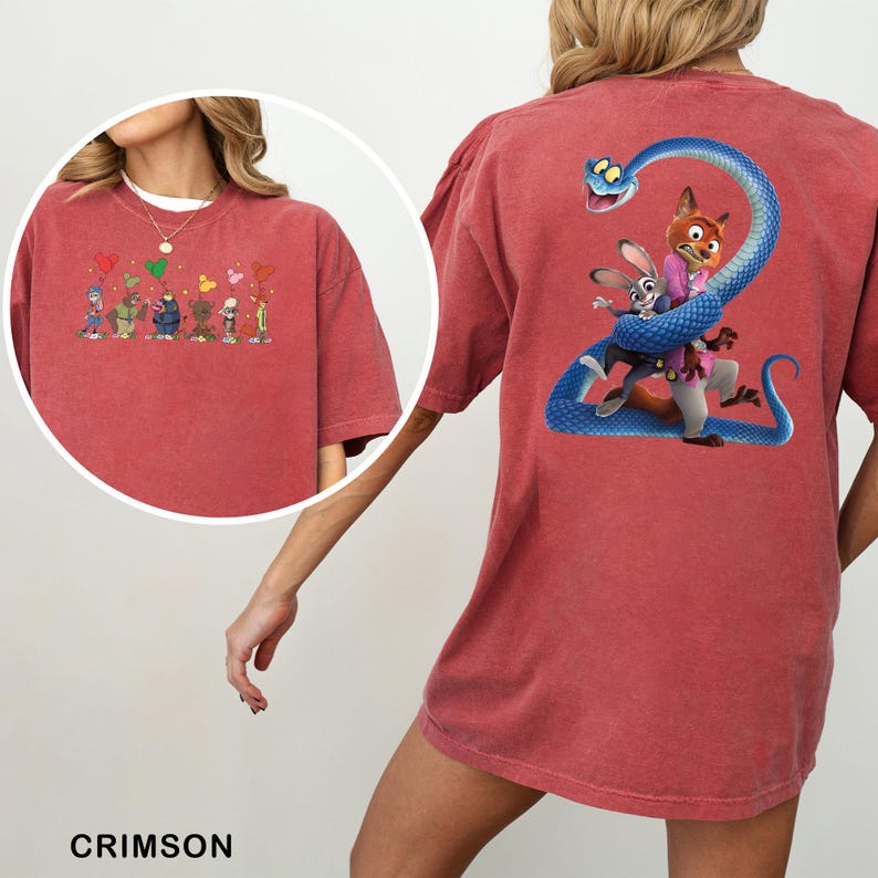 K&ouml;nnte beinhalten: Karmesinrotes T-Shirt mit Cartoon-Grafiken auf der Vorder- und R&uuml;ckseite. Die Vorderseite zeigt Cartoon-Figuren mit Luftballons. Die R&uuml;ckseite zeigt einen Fuchs und ein Kaninchen mit einer blauen Schlange. Das Shirt hat eine lockere, &uuml;bergro&szlig;e Passform.