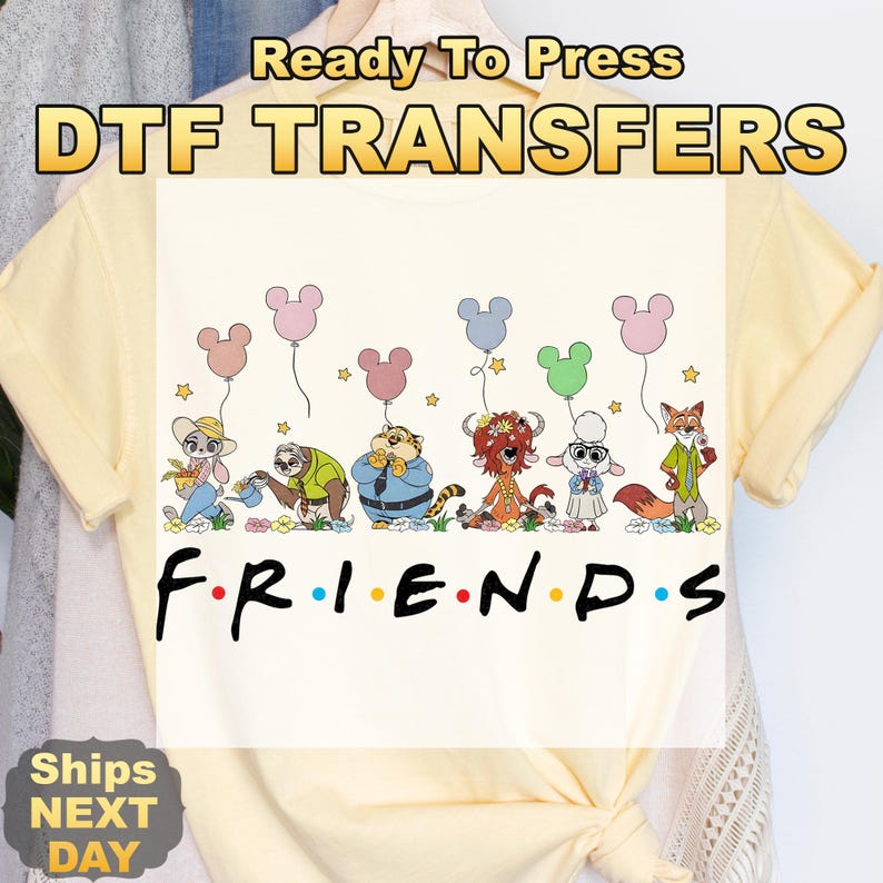 May include: Cream-colored t-shirt featuring a cartoon design of animal characters holding Mickey Mouse-shaped balloons. The word "FRIENDS" is written in a black font. The text "Ready To Press DTF TRANSFERS" is at the top.