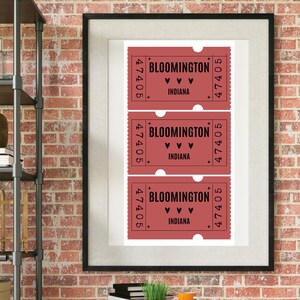 May include: Framed print featuring three vintage-style tickets. Each ticket is a shade of red with the text "BLOOMINGTON" and "INDIANA", along with the number "47405". The tickets have a decorative border and heart symbols.