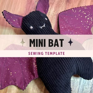 May include: A plush bat toy made of black corduroy fabric with purple inner ears and wings featuring a gold speckled pattern. The bat has embroidered eyes and fangs. Text on the image reads MINI BAT SEWING TEMPLATE with star icons.