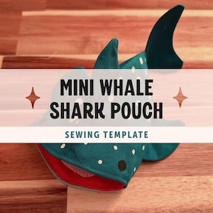 May include: A teal fabric pouch shaped like a whale shark with white polka dots and a red interior lining. The text on the image reads MINI WHALE SHARK POUCH SEWING TEMPLATE. The pouch features a dorsal fin and a tail fin, designed as a craft project.