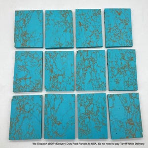 May include: Twelve rectangular turquoise slabs arranged in three rows of four. Each slab features a vibrant cyan blue base colour with intricate, branching brown matrix patterns spread across the flat, smooth surfaces of the stone pieces.