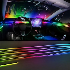 May include: Car interior with multi-coloured LED lighting, including red, orange, yellow, green, blue, and purple. The dashboard screen displays the word "MUSIC" and musical notes. The steering wheel is black.