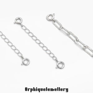 May include: Three silver-colored chain extenders with different link styles are displayed against a white background. Each extender has a clasp on both ends. The text "OrphiqueJewellery" is at the bottom.