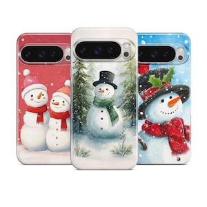 May include: Three phone cases with winter-themed designs. One case features two snowmen with red scarves and pink hats against a red background. Another shows a snowman in a forest with a black hat and green scarf. The third case has a snowman with a black hat and red scarf against a blue background.