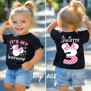 May include: Black t-shirt with a Minnie Mouse design for a child's birthday. The front says "It's My Birthday" with a Minnie Mouse graphic and the back has the name "Juliette" and the number "3". The child is wearing blue denim shorts.