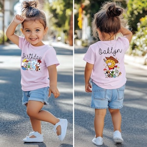 K&ouml;nnte beinhalten: Hellrosa T-Shirt mit dem Aufdruck "Birthday Girl" und Cartoonfiguren. Auf der R&uuml;ckseite des Shirts steht der Name "Oaklyn" und ein Cartoon-Design. Dazu Jeansshorts und wei&szlig;e Schuhe.