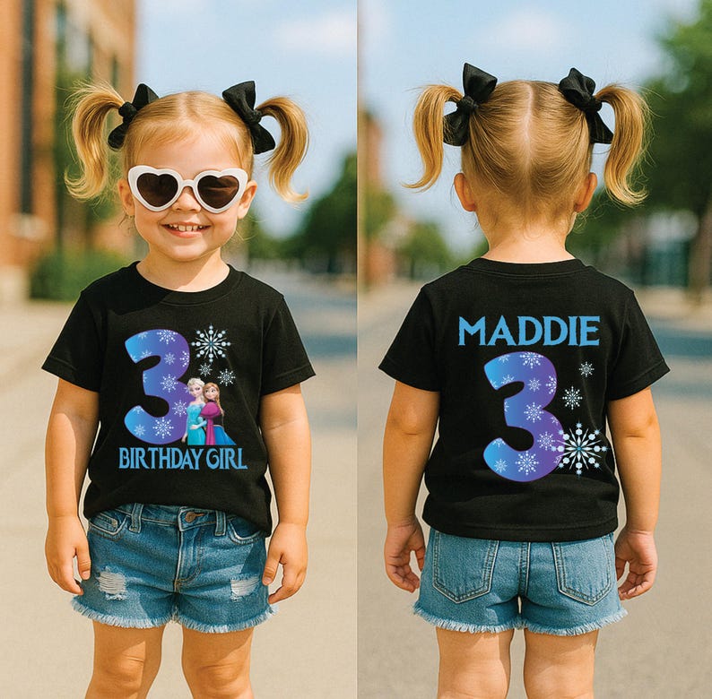 K&ouml;nnte beinhalten: Ein schwarzes T-Shirt mit einer blau-violetten Zahl 3 und einem Schneeflocken-Design. Auf der Vorderseite des Shirts steht "BIRTHDAY GIRL" und zeigt eine Grafik von zwei Charakteren. Auf der R&uuml;ckseite des Shirts steht "MADDIE" und hat eine 3.