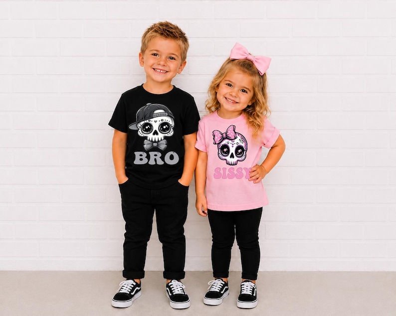 May include: A black t-shirt with a graphic of a skull wearing a baseball cap and the text BRO, paired with black pants, and a light pink t-shirt with a graphic of a skull wearing a pink bow and the text SISSY, paired with black pants.