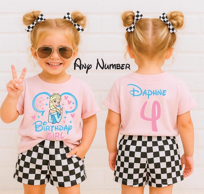 May include: A light pink t-shirt featuring a graphic of a blonde character in a blue dress with the text Birthday Girl and mouse ears. The back displays the name Daphne and the number 4. The outfit includes black and white checkered shorts.