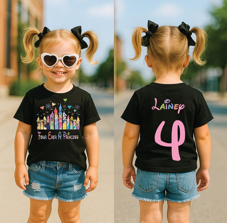 May include: A black t-shirt with a colorful castle graphic and the text "Four Ever A Princess" on the front. The back of the shirt has the name "Lainey" and the number "4" in pink.