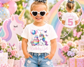 May include: A white short-sleeved t-shirt featuring a graphic of a unicorn, a multi-tiered birthday cake, balloons, and butterflies with the text Birthday Girl. The back of the shirt displays the name Sydney and the number 5 in pink.