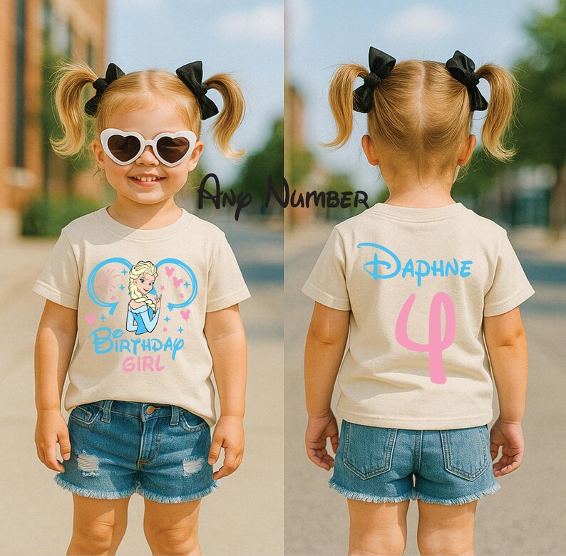 May include: A beige short-sleeve t-shirt featuring a graphic of a blonde character in a blue dress with the text Birthday Girl in blue and pink. The back displays the name Daphne in blue and the number 4 in pink. The text Any Number is visible.