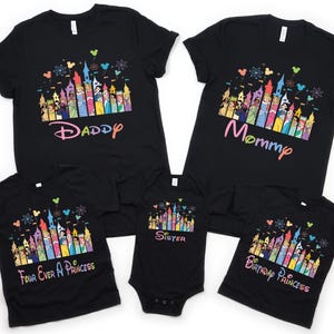 May include: Black t-shirts with colorful castle and character designs. The shirts have text that says "Daddy", "Mommy", "Four Ever A Princess", "Sister", and "Birthday Princess". The shirts are for a family.