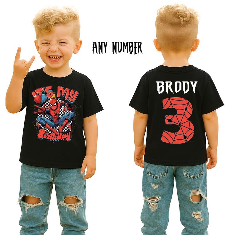 May include: Black t-shirt featuring a Spider-Man graphic and the text "It's My Birthday". The back of the shirt has the name "Brody" and the number "3" with a spiderweb design. The child is wearing blue jeans.