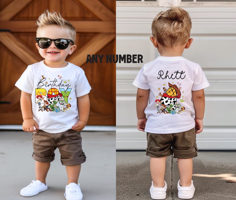 May include: White t-shirt with a colorful graphic featuring cartoon characters and the word "Birthday BOY". The back of the shirt has the name "Rhett" and a similar graphic. The child is wearing brown shorts and white sneakers.