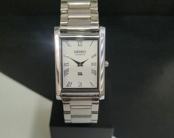 Odnowiony zegarek kwarcowy Seiko Slim z białą tarczą i srebrną bransoletą: prostokątny zegarek w stylu vintage