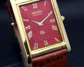 Seiko Slim Quartz Red Face Tan band Watch: Vintage Rectangular Dress Style