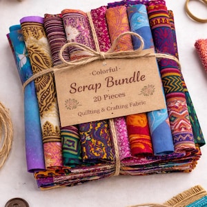 May include: A colourful scrap bundle of 20 pieces of quilting and crafting fabric, tied with twine. The fabric features various patterns and colours, including blue, purple, orange, and pink. A tag reads "Colorful Scrap Bundle".