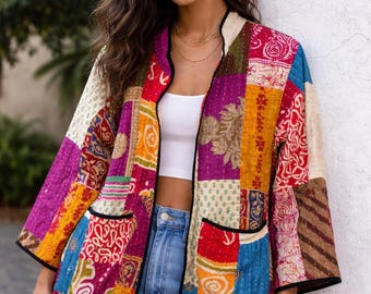 May include: A patchwork jacket in a variety of colors, including purple, orange, and red. The jacket has a black trim and two front pockets. The jacket is made of a quilted fabric and has a loose fit.