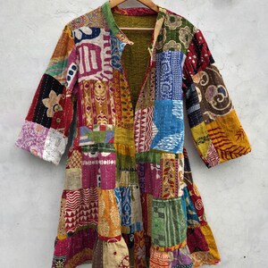 May include: A patchwork jacket with a variety of colorful fabric patterns. The jacket features a collar and long sleeves. The design includes a mix of floral, geometric, and abstract shapes in shades of red, blue, yellow, and green.