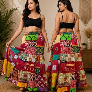 May include: A patchwork maxi skirt with a vibrant mix of colors and patterns. The skirt features a tiered design with various fabric patches in red, yellow, green, and blue. The skirt is worn with a black crop top.