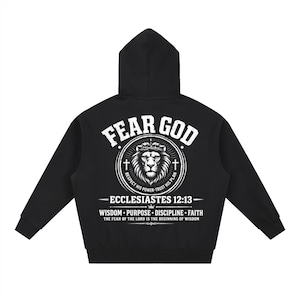 May include: Black hooded sweatshirt with the text "FEAR GOD" in white, above a lion illustration. Below the lion is the text "ECCLESIASTES 12:13" and other text. The sweatshirt has long sleeves and a hood.