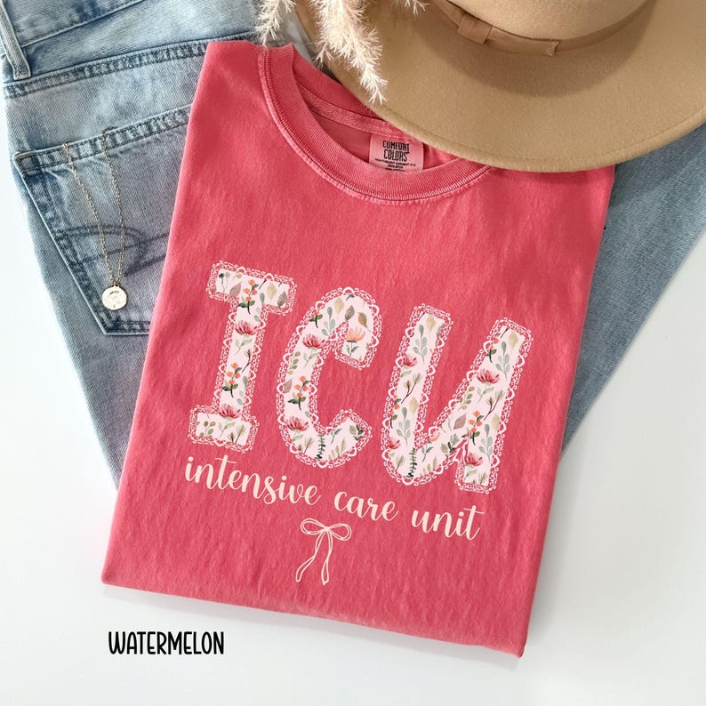 A "Watermelon" Comfort Colors t-shirt, featuring the letters "ICU" in a block font filled with a green, pink, and white floral pattern with a decorative border, and the words "intensive care unit" and a bow below.