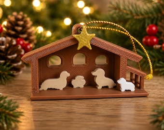 May include: A brown plastic nativity scene ornament featuring a gold star at the peak of the roof. Inside the structure are four small, light-colored dog figurines arranged in a row. A gold string is attached to the top for hanging purposes.