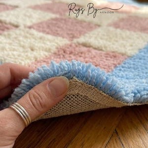 Folded rug corner showing construction, backing, and handcrafted quality.