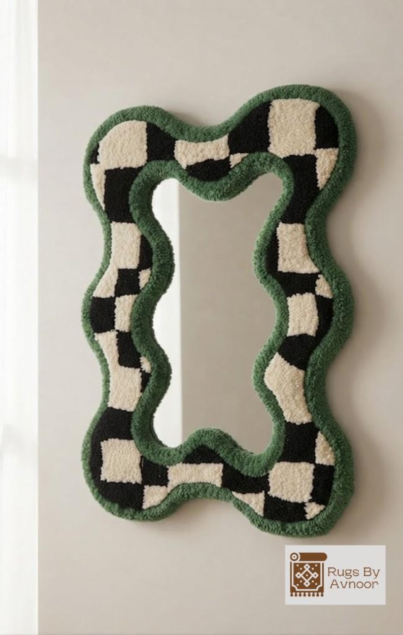 Front view of a handmade wavy checkerboard mirror with a forest green tufted frame on a neutral wall.