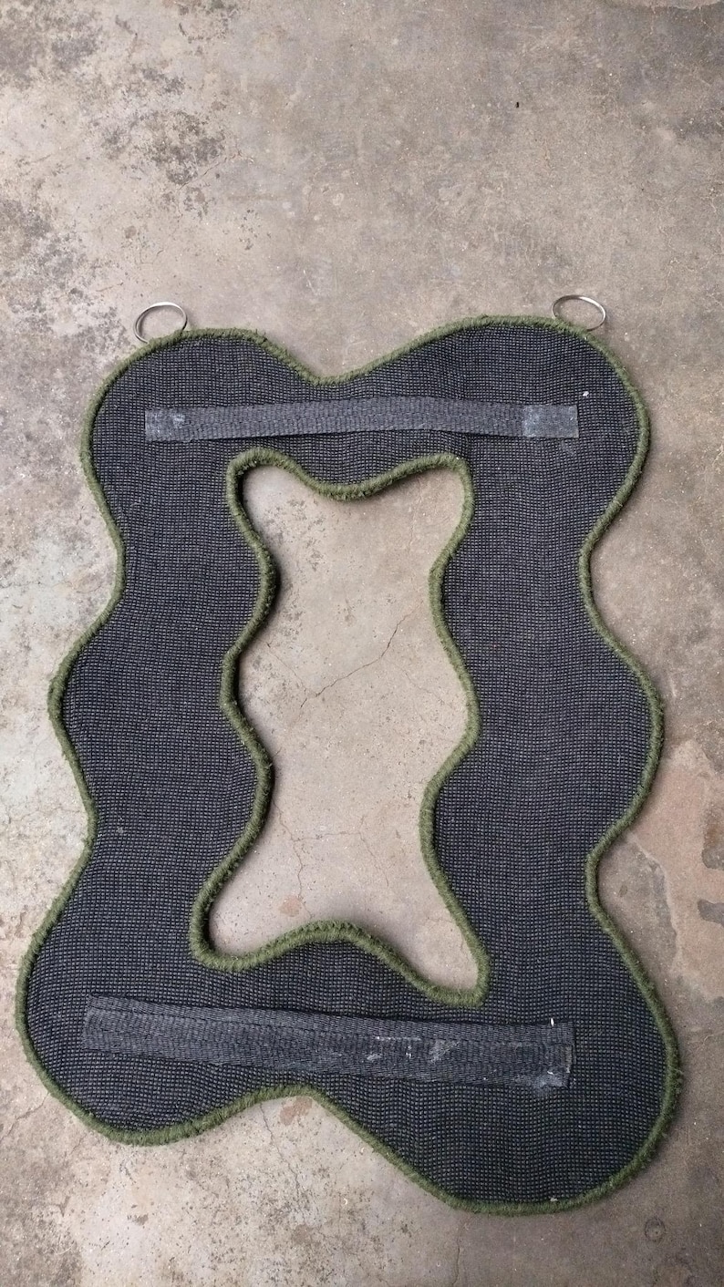 Bcaking of tuft mirror showing straps and metal hanging