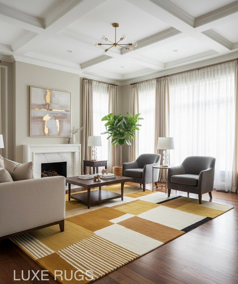 May include: A modern living room featuring a geometric patterned rug in shades of gold, brown, and white. The room includes a sofa, two gray armchairs, a coffee table, and a fireplace. The text "LUXE RUGS" is visible at the bottom.